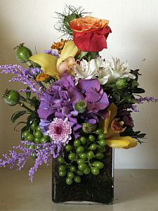Every day arrangement made of solidago, roses, hortensia, cymbidium and alstromeria coloured